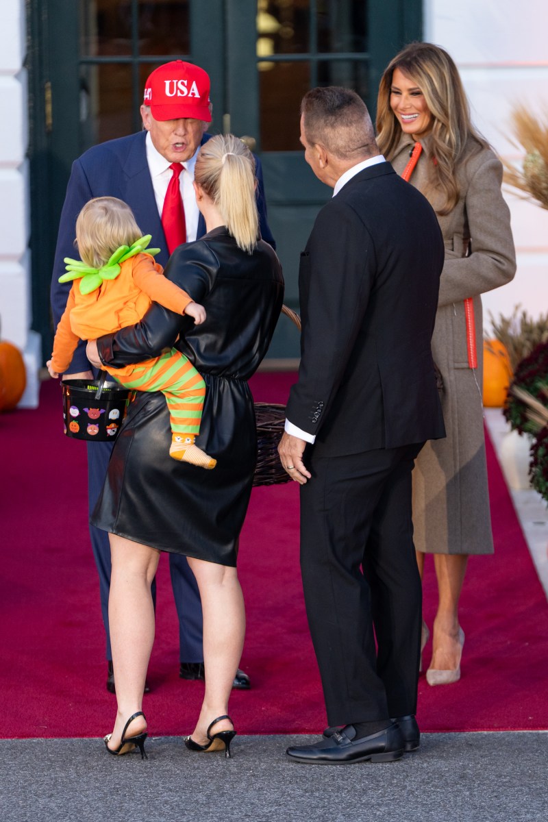 President Donald Trump and First Lady Melania Trump hand out candy to trick-or-treaters at the South Portico during Halloween celebrations at the White House, Thursday, October 30, 2025. (Official White House Photo by Cody Hendrix)