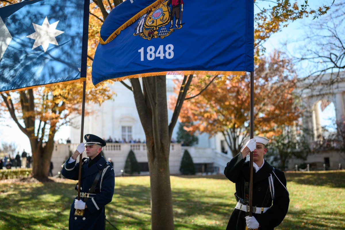 Members of the military stand at attention as President Donald Trump arrives for a wreath-laying ceremony at the Tomb of the Unknown Soldier in observance of Veterans Day, Tuesday, November 11, 2025, at Arlington National Cemetery in Arlington, Virginia. (Official White House Photo by Daniel Torok)