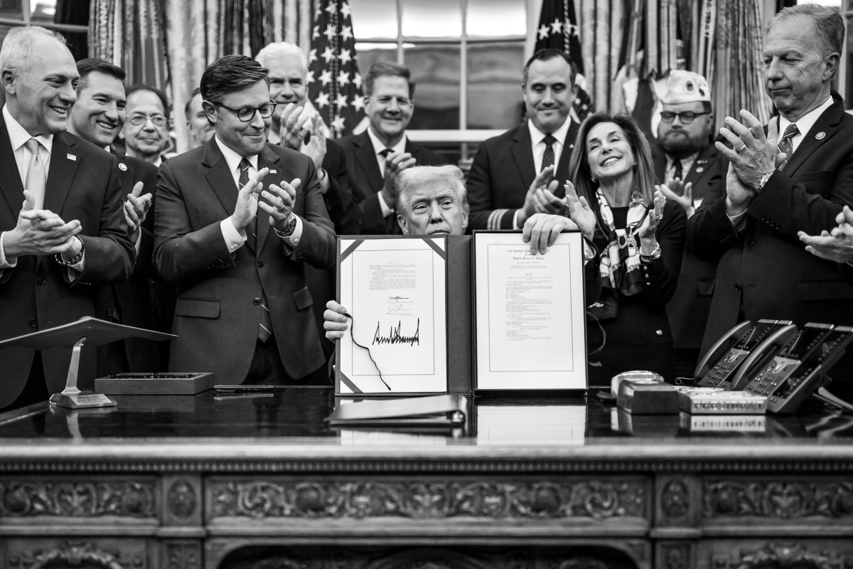 President Donald Trump shows members of the media the signed bill from Congress that reopens the government, Wednesday, November 12, 2025, in the Oval Office. (Official White House Photo by Daniel Torok)