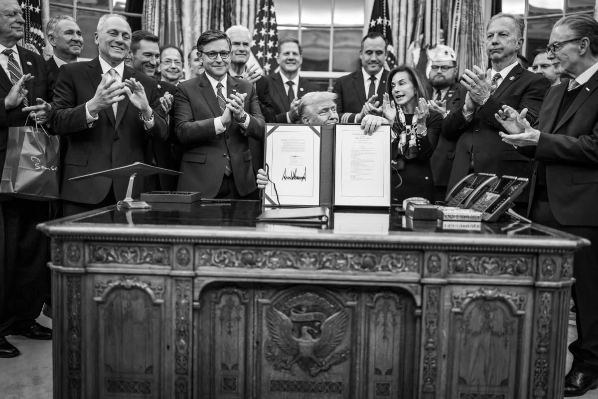 President Donald Trump shows members of the media the signed bill from Congress that reopens the government, Wednesday, November 12, 2025, in the Oval Office. (Official White House Photo by Daniel Torok)
