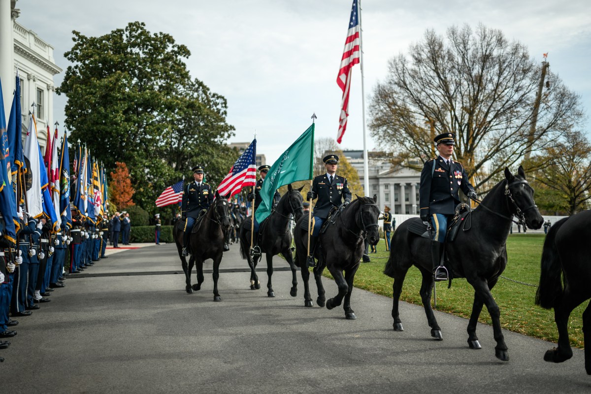 Soldiers on horseback pass President Donald Trump during a welcome ceremony for Crown Prince and Prime Minister Mohammed bin Salman Al Saud of Saudi Arabia at the South Portico of the White House, Tuesday, November 18, 2025. (Official White House Photo by Daniel Torok)
