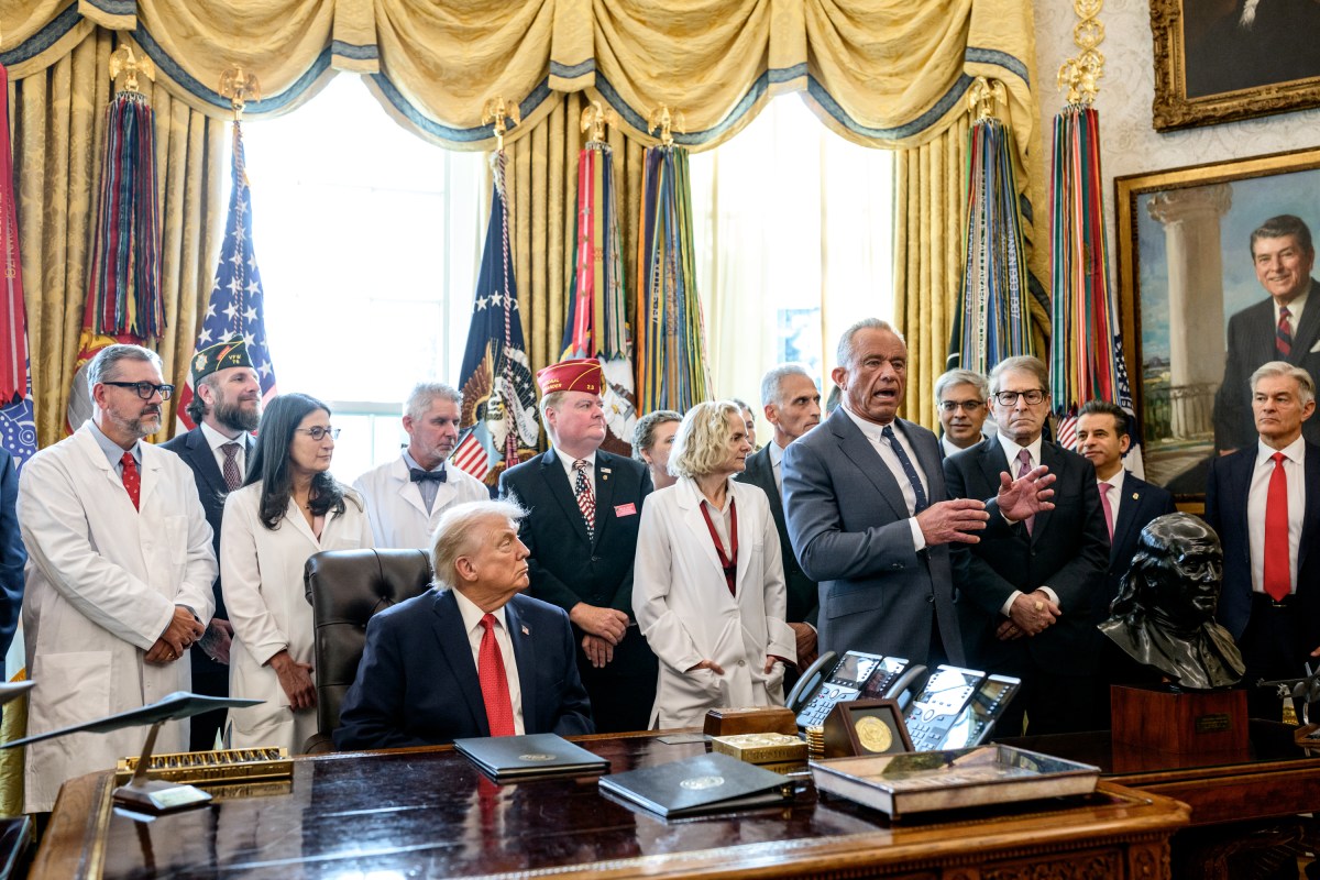 President Donald Trump signs an executive order reclassifying marijuana as a Schedule III substance with looser restrictions in the Oval Office, Thursday, December 18, 2025. (Official White House Photo by Molly Riley)