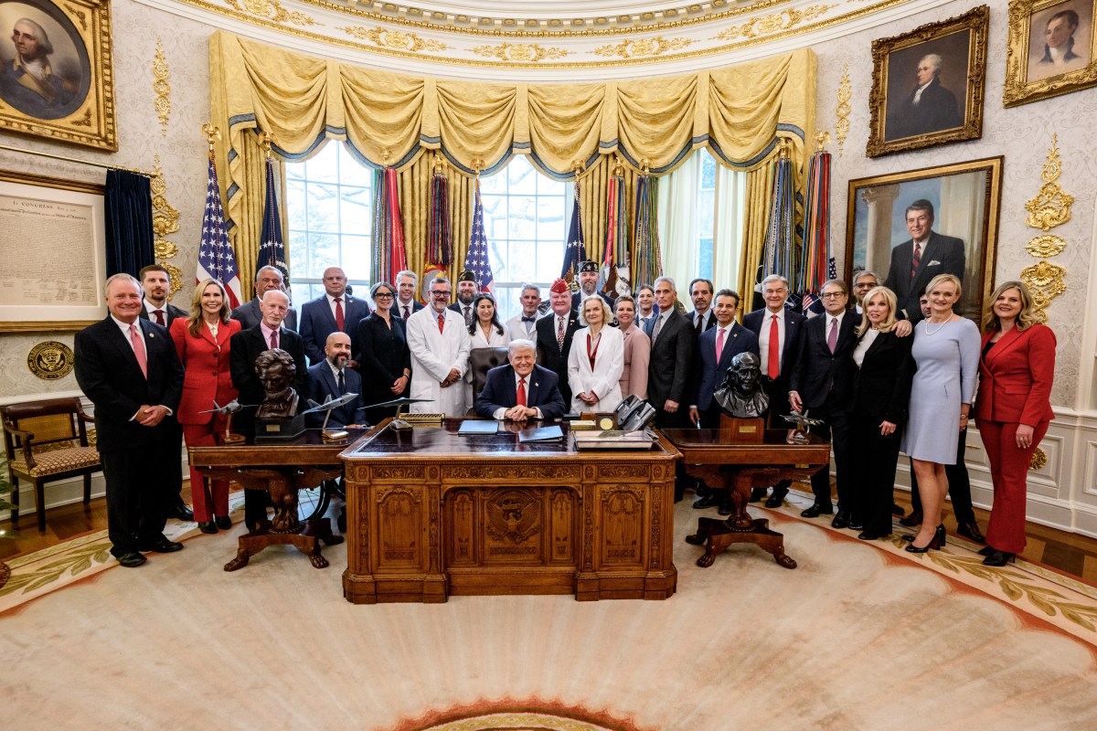 President Donald Trump signs an executive order reclassifying marijuana as a Schedule III substance with looser restrictions in the Oval Office, Thursday, December 18, 2025. (Official White House Photo by Molly Riley)