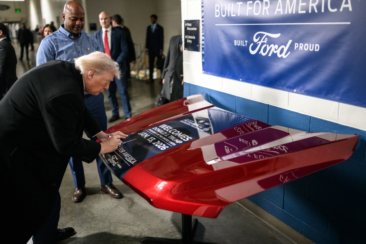 President Donald Trump signs a vehicle hood at the Ford River Rouge Complex in Dearborn, Michigan on Tuesday, January 13, 2026. (Official White House Photo by Daniel Torok)