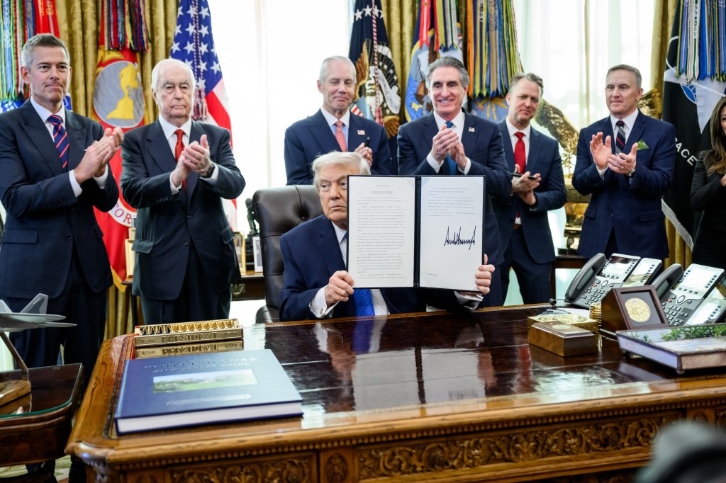 President Donald Trump signs an executive order bringing IndyCar racing to Washington, D.C., Friday, January 30, 2026, in the Oval Office. President Trump is joined by Secretary of Transportation Sean Duffy, Secretary of Interior Doug Burgum, Penske Corporation Chair Roger Penske, and Penske Corporation President Bud Denker. (Official White House Photo by Molly Riley)
