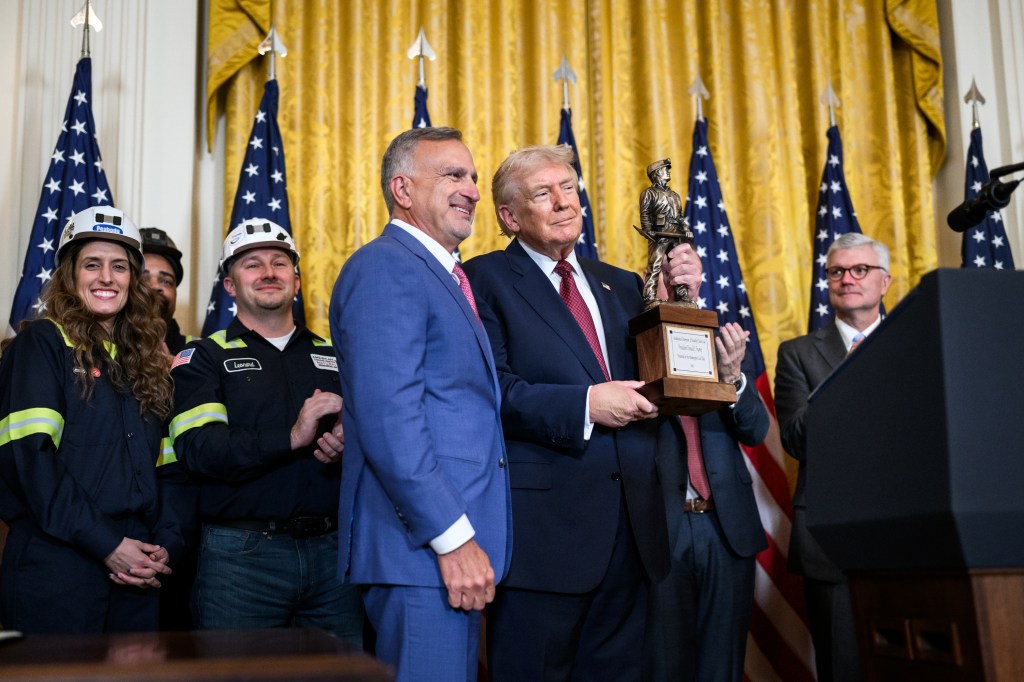 President and CEO of Peabody Energy Jim Grech presents an award to President Donald Trump at a Champion of Coal event in the East Room of the White House, Wednesday, February 11, 2026. (Official White House Photo by Molly Riley)