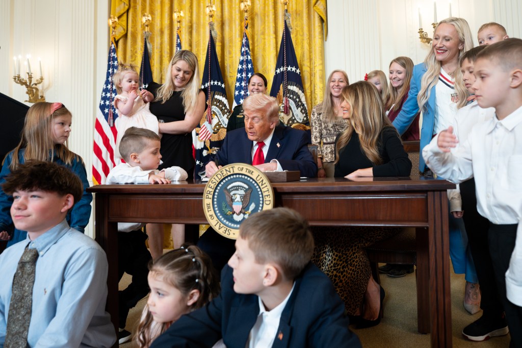 President Donald J. Trump, joined by First Lady Melania Trump, signs a proclamation at an event celebrating Women’s History Month and National Working Mom’s Day, Thursday, March 12, 2026, in the East Room of the White House. (Official White House Photo by Andrea Hanks)