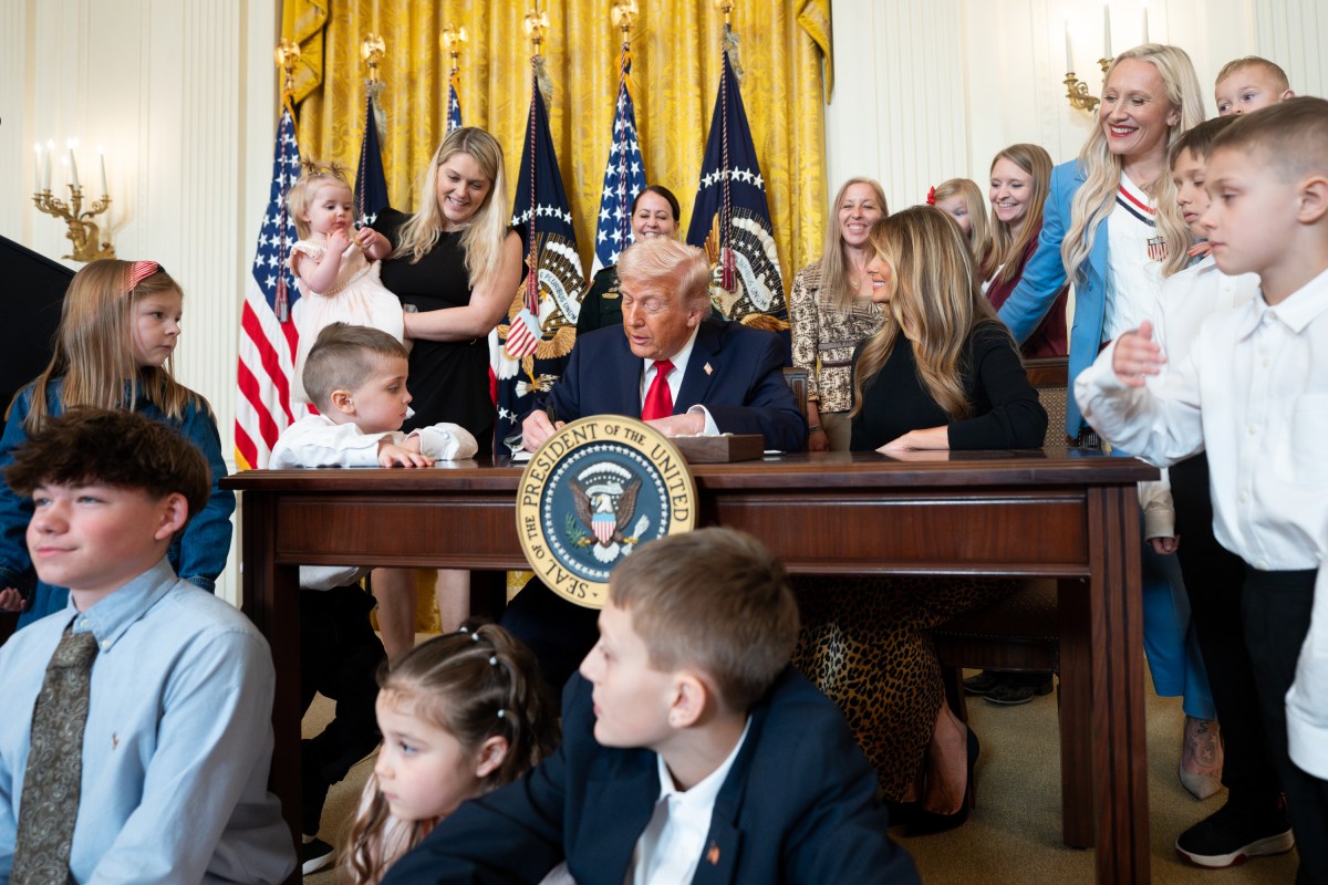President Donald J. Trump, joined by First Lady Melania Trump, signs a proclamation at an event celebrating Women’s History Month and National Working Mom’s Day, Thursday, March 12, 2026, in the East Room of the White House. (Official White House Photo by Andrea Hanks)