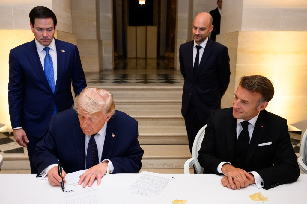 President Donald J. Trump signs a Memorandum of Understanding between the Islamic Republic of Iran and the United States of America at the Palace of Versailles, France on Wednesday, June 17, 2026. French President Emmanuel Macron and First Lady Brigitte Macron of were also in attendance. (Official White House Photo by Daniel Torok)