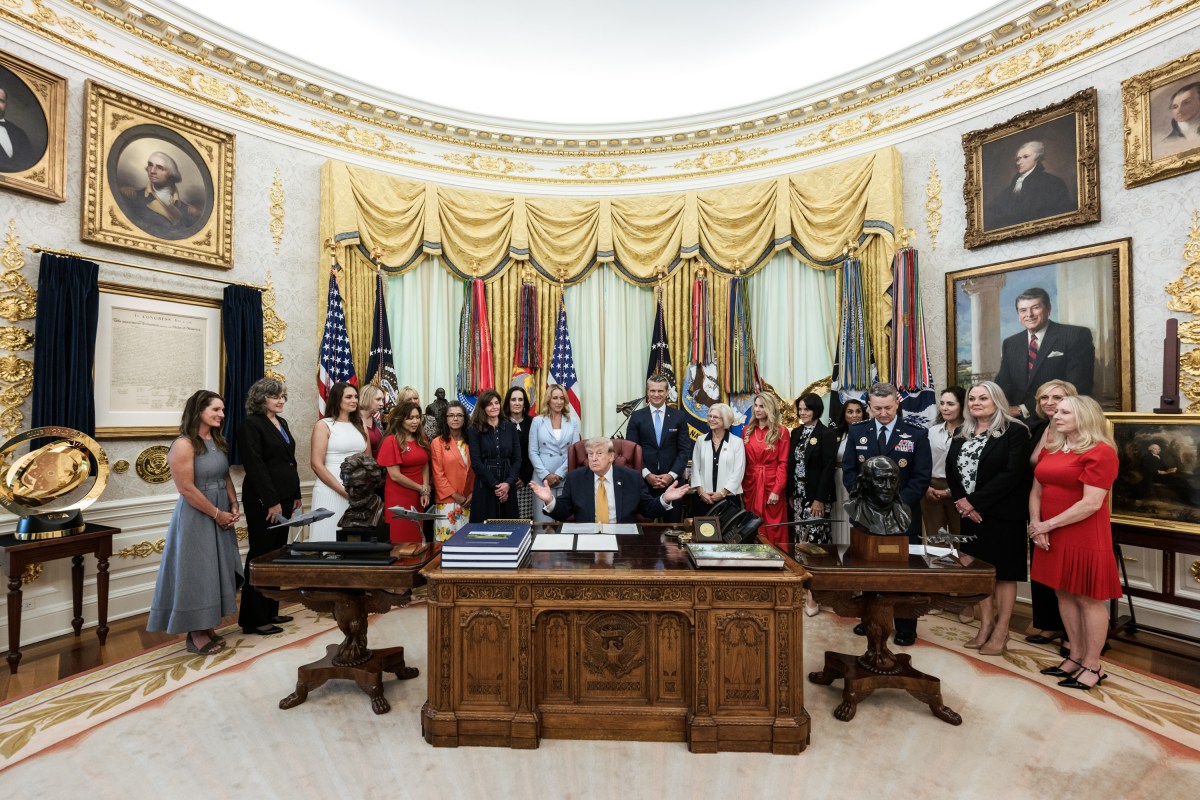 President Donald J. Trump, joined by Secretary of War Pete Hegseth and wife Jennifer Hegseth, signs an executive order creating a new White House commission focused on military families, Monday, August 3, 2026, in the Oval Office. (Official White House Photo by Molly Riley)