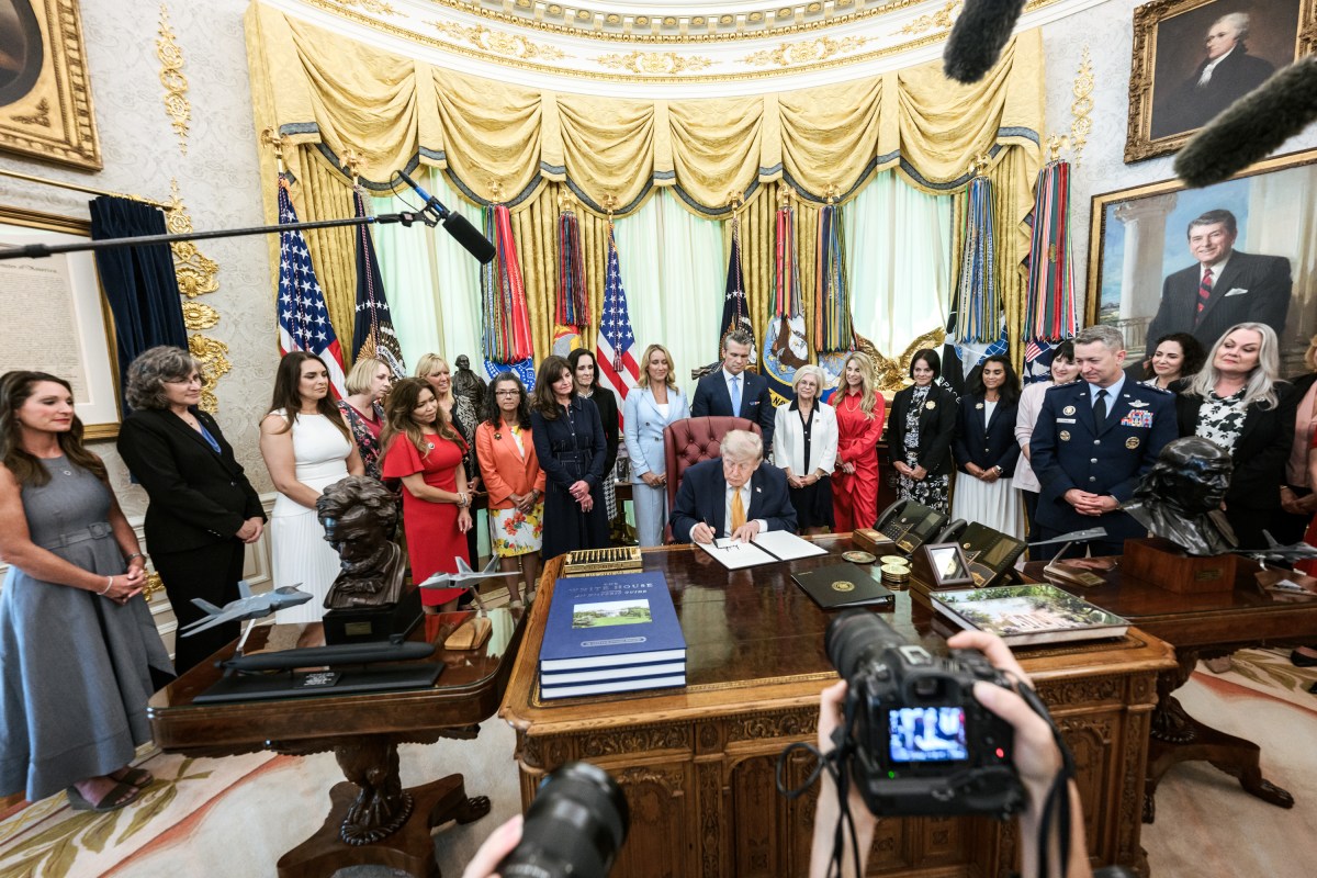 President Donald J. Trump, joined by Secretary of War Pete Hegseth and wife Jennifer Hegseth, signs an executive order creating a new White House commission focused on military families, Monday, August 3, 2026, in the Oval Office. (Official White House Photo by Molly Riley)