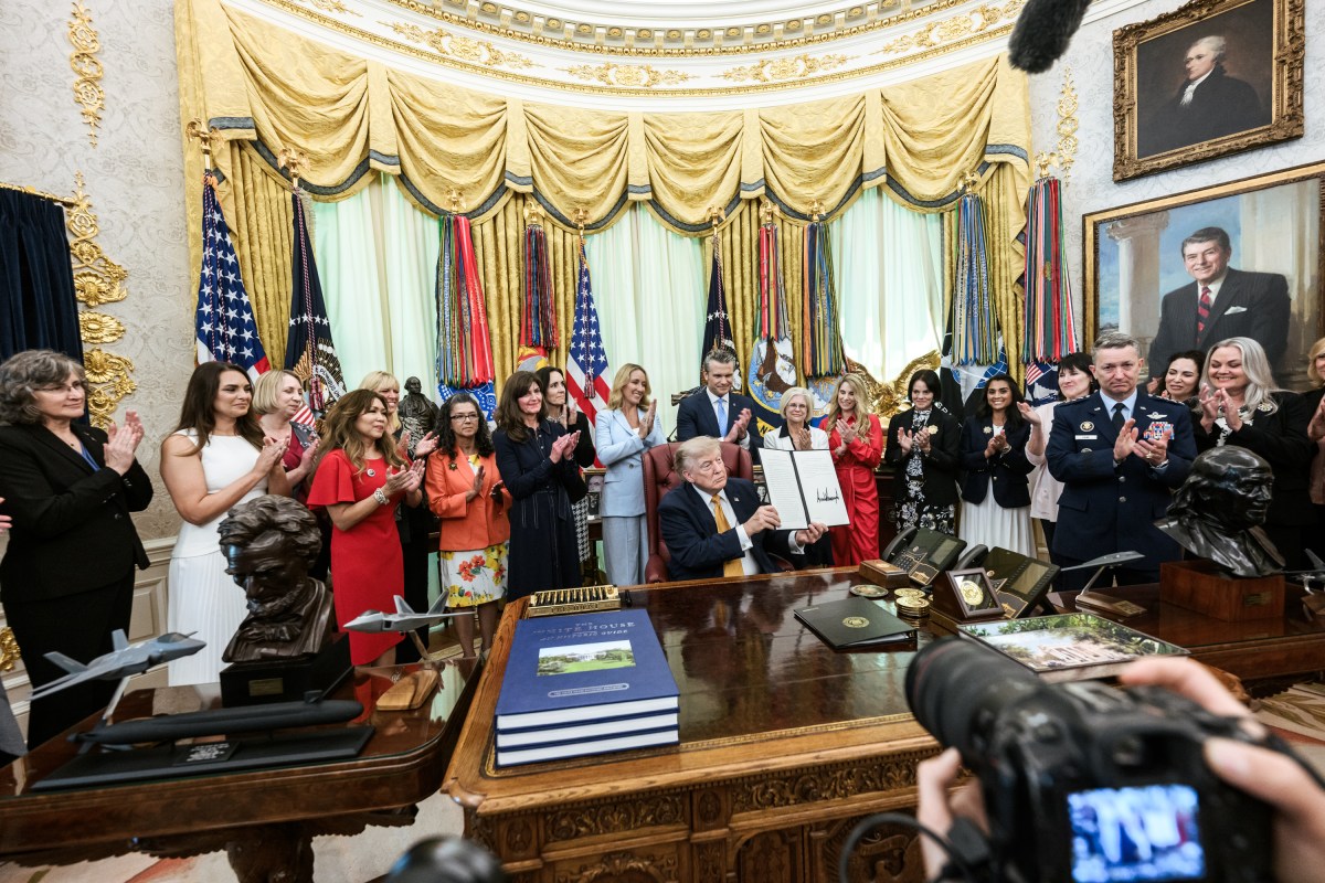 President Donald J. Trump, joined by Secretary of War Pete Hegseth and wife Jennifer Hegseth, signs an executive order creating a new White House commission focused on military families, Monday, August 3, 2026, in the Oval Office. (Official White House Photo by Molly Riley)