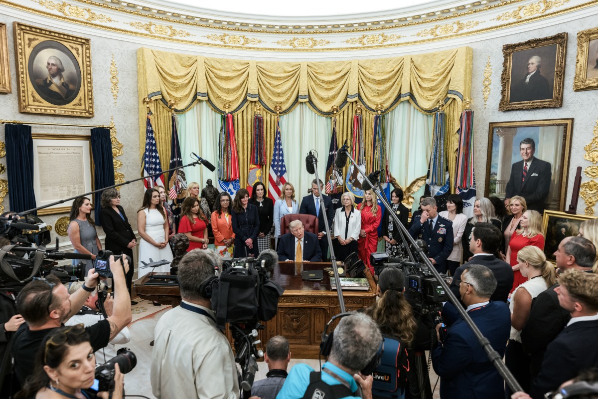 President Donald J. Trump, joined by Secretary of War Pete Hegseth and wife Jennifer Hegseth, signs an executive order creating a new White House commission focused on military families, Monday, August 3, 2026, in the Oval Office. (Official White House Photo by Molly Riley)