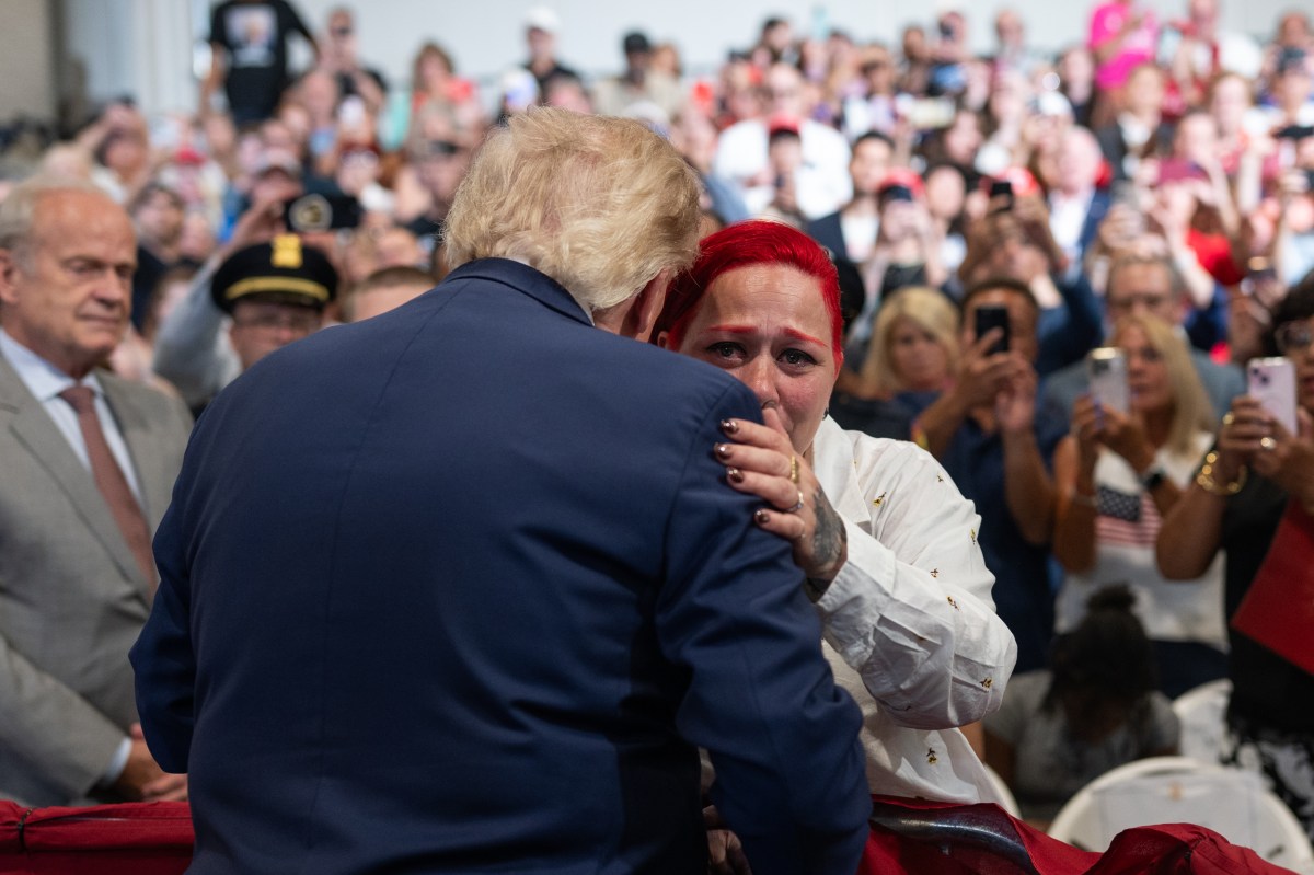 President Donald J. Trump embraces Migdalia Martinez, mother of 12-year-old Jacob Freytes, as he delivers remarks at the David S. Mack Center for Training and Intelligence in Garden City, New York, Friday, August 14, 2026. (Official White House Photo by Molly Riley)