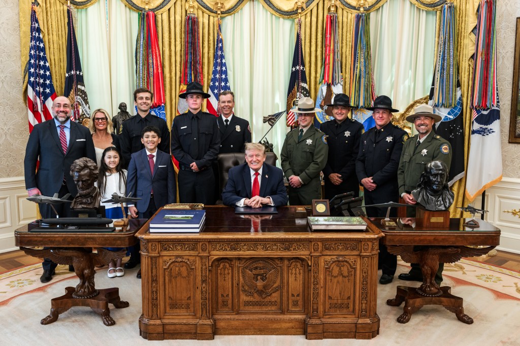 President Donald J. Trump meets with hero-lifeguard Ryder Williams, 16, and Nathaniel Nai, 10, and their families and Santa Cruz officials in the Oval Office, Monday, August, 17, 2026. Williams rescued Nai from rough surf at Seabright State Beach in Santa Cruz, California on July 25, 2026. (Official White House Photo by Daniel Torok)