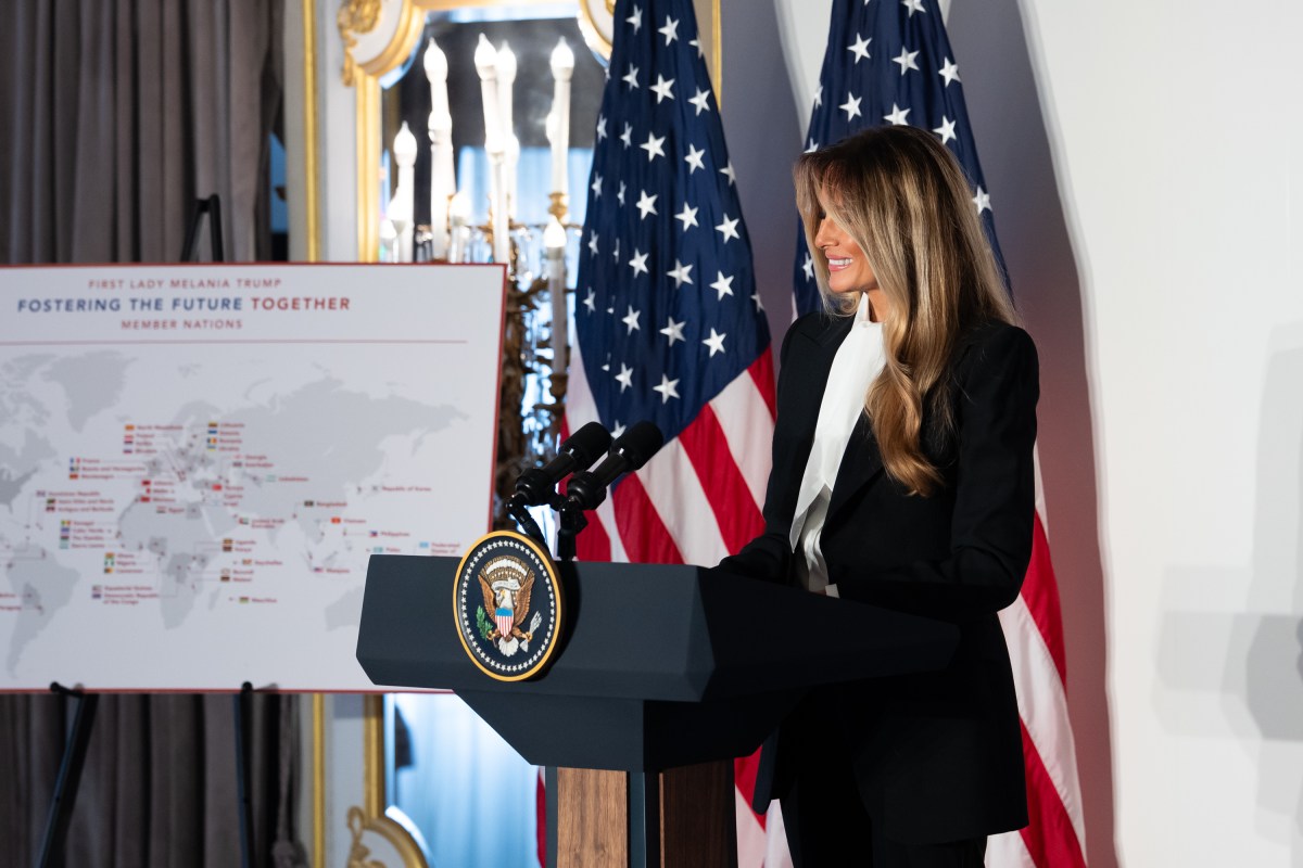 Melania Trump stands at a lectern beside a map of countries in the Fostering the Future Together initiative.