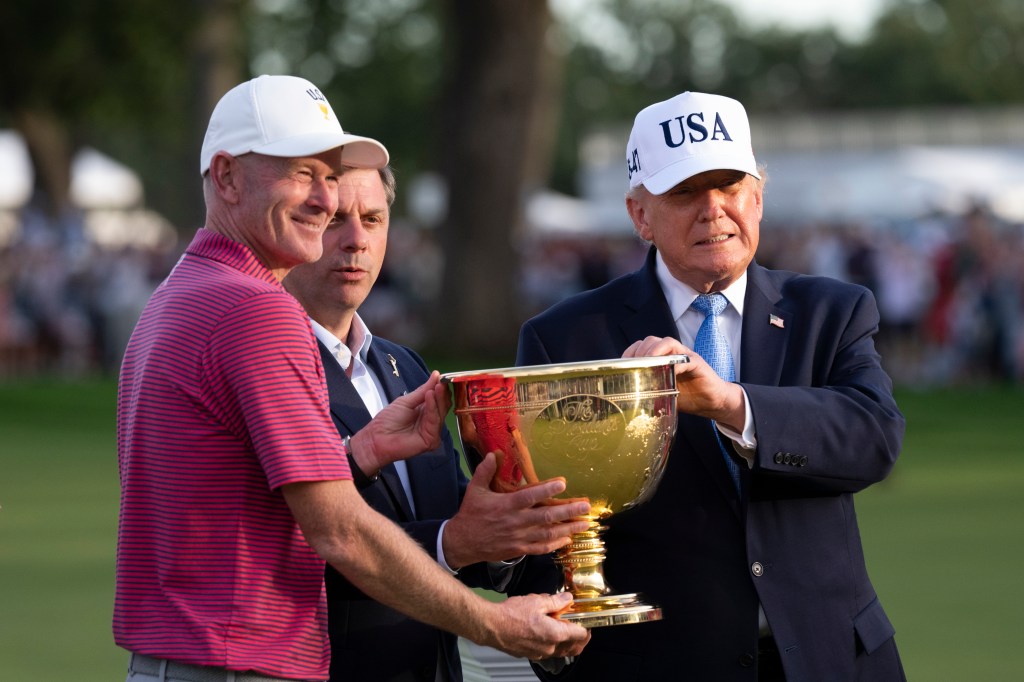 President Donald J. Trump and PGA Tour CEO Brian Rolapp present the President’s Cup Trophy to the USA Team Captain Brandt Snedeker after winning the 2026 President’s Cup on Sunday, September 27, 2026, at Medinah Country Club in Medinah, Illinois. (Official White House photo by Joyce N. Boghosian)