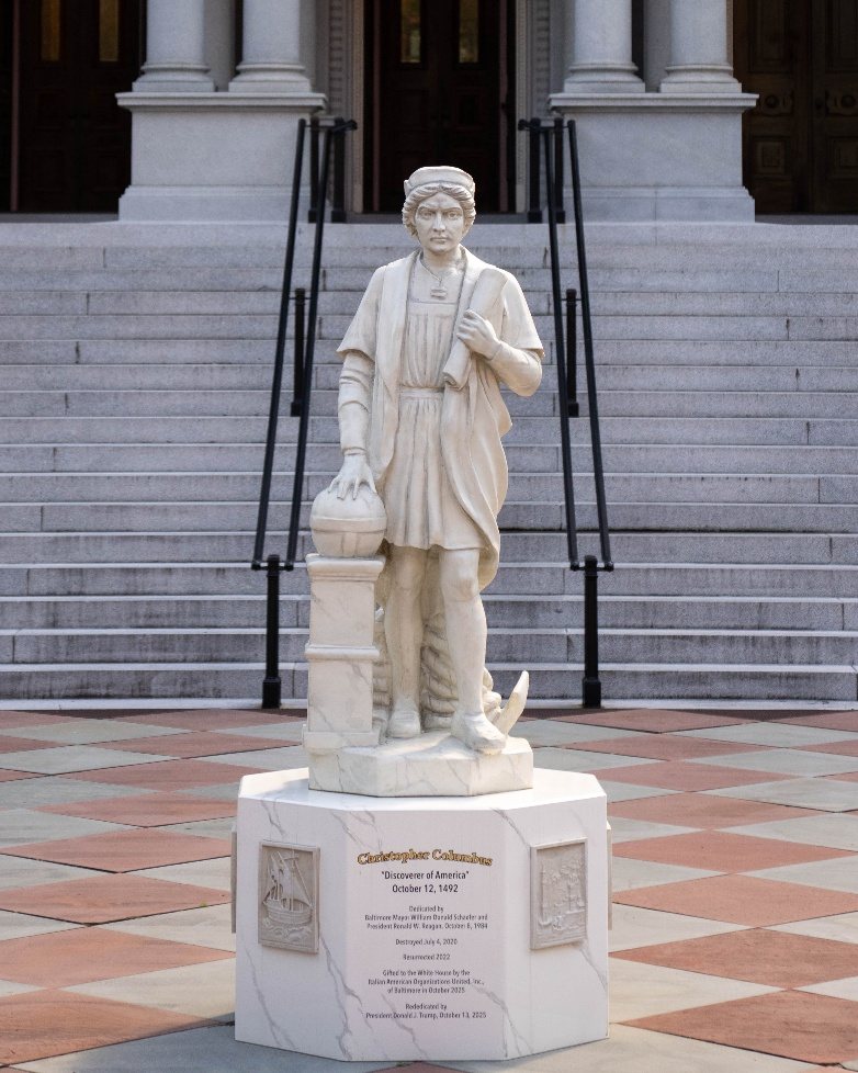 Marble statue of Columbus with his hand on a globe, in front of the Eisenhower Executive Office Building